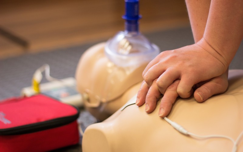 Someone learning how to do CPR on Busy Bees Education and Training’s First Aid training course.