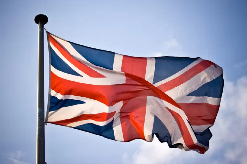 A union jack flag waving in the sky